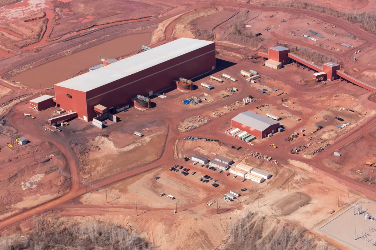 Aerial view of a large production facility with smaller surrounding buildings