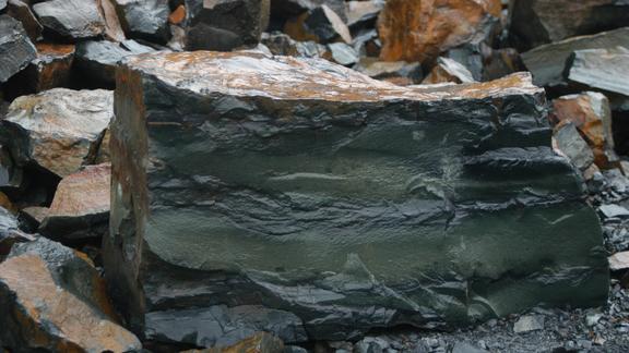 Close up image of grey rock to show layered stripping