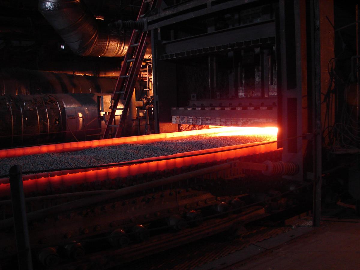 Red hot taconite pellets coming out of an industrial furnace