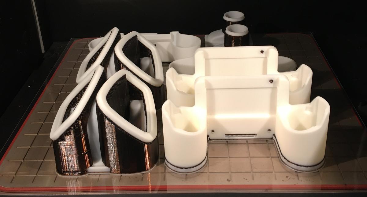 Plastic parts on a tray viewed through a machine window