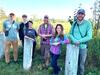 NRRI avian ecology team gather, six ecologists, male and female, smile at the camera with a wetland in the background. 